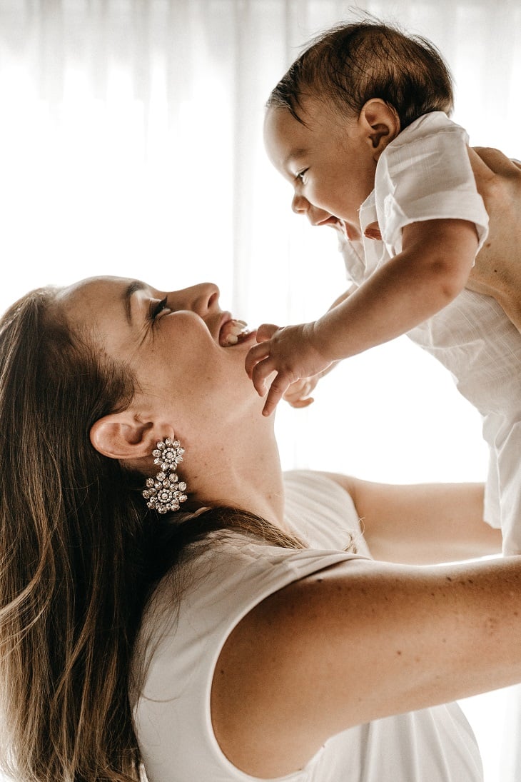 Happy mother and baby after a good night's sleep. Momma is able to enjoy her baby and succeed at her job because they are both getting the sleep needed to thrive. The executive mommy sleep package from the peaceful sleeper works for you so you can work
