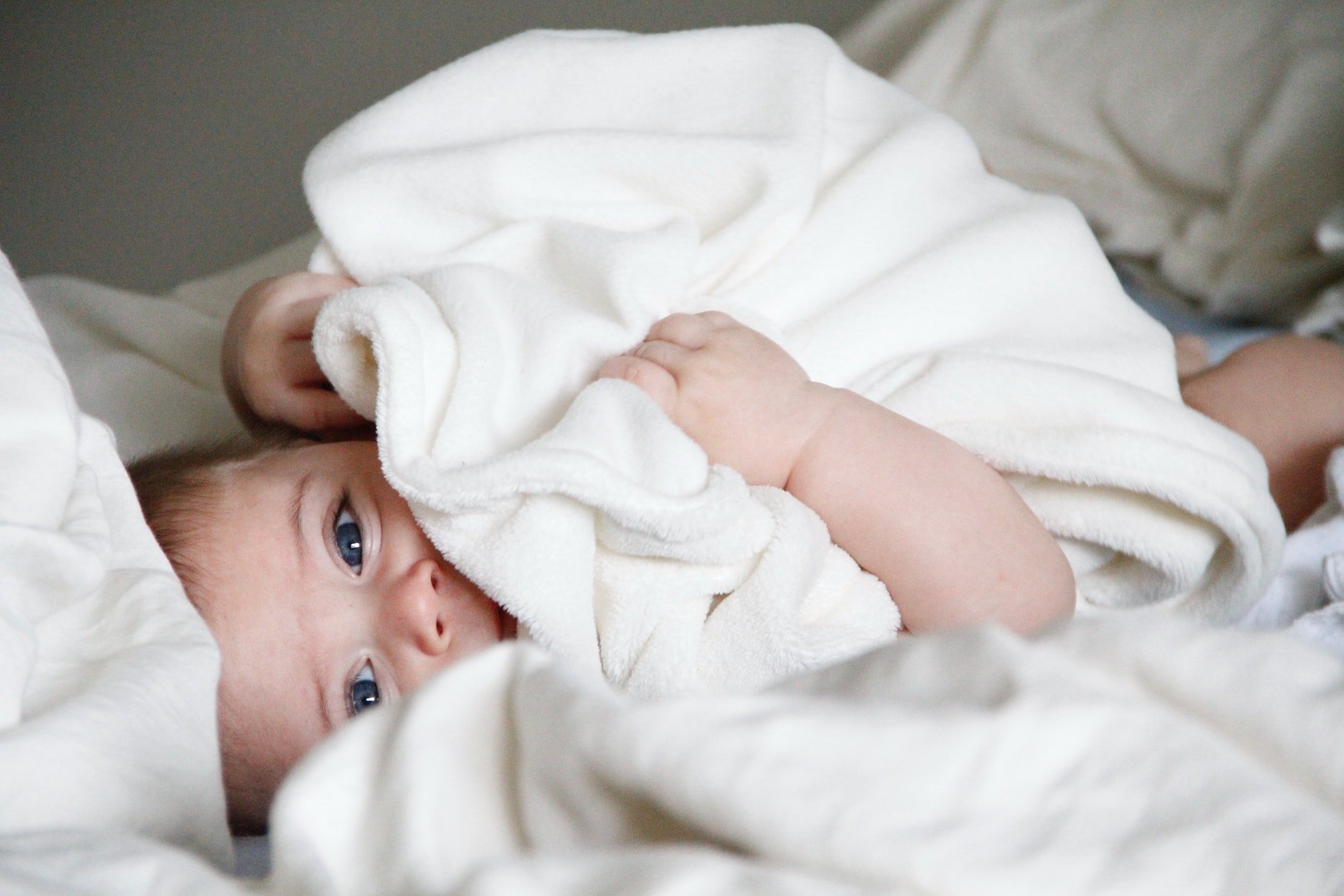 baby laying in bed after sleeping | The Peaceful Sleeper