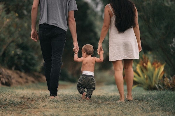 parents walking with their baby after a nap | The Peaceful Sleeper 
