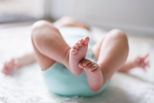 a baby about to do bicycle kicks on their back | The Peaceful Sleeper 