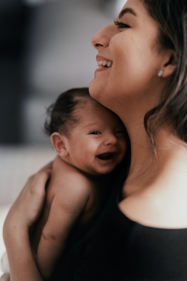 a mother rocking her baby | The Peaceful Sleeper 