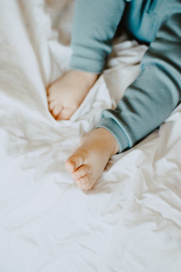 baby feet in a bed | The Peaceful Sleeper 