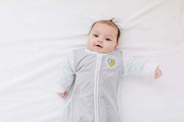 Baby in a sleep sack which is a great option for clothes while sleeping |The Peaceful Sleeper