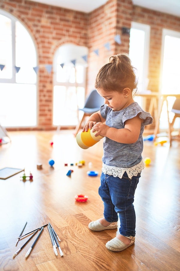 a young toddler about 18 months old playing with toys instead of napping | The Peaceful Sleeper 