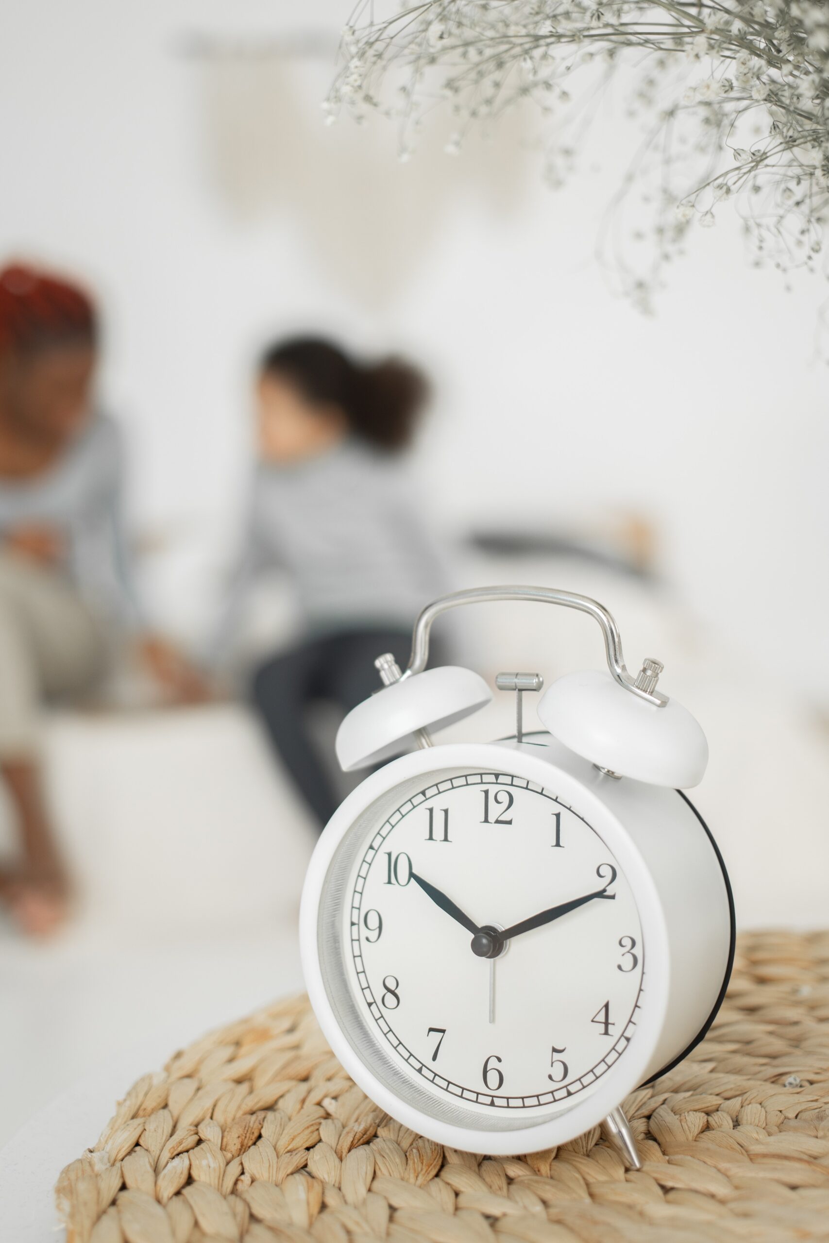 family looking at a clock around daylight savings trying to adjust their baby's sleep schedule | The Peaceful Sleeper