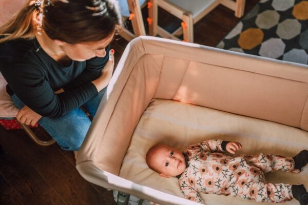 Parent with baby going to sleep as an alternative to cry it out sleep training | The Peaceful Sleeper