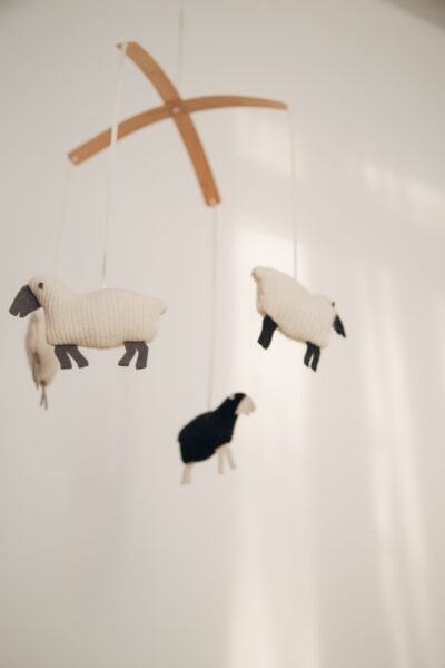 baby mobile with sheep above a baby's crib |The Peaceful Sleeper 