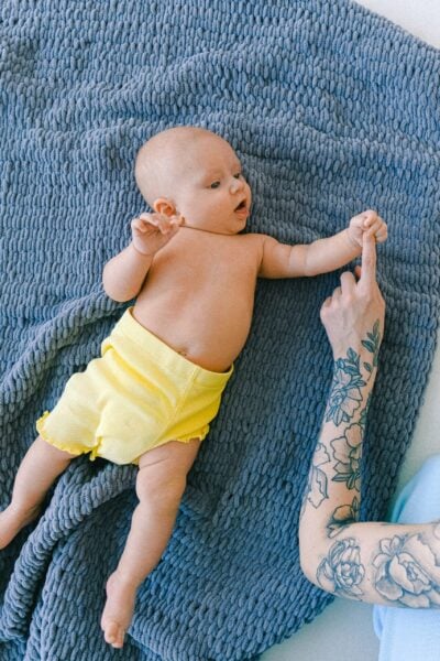 baby laying on a blanket with mom | The Peaceful Sleeper