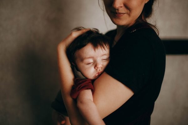 napping toddler in moms arms | The Peaceful Sleeper
