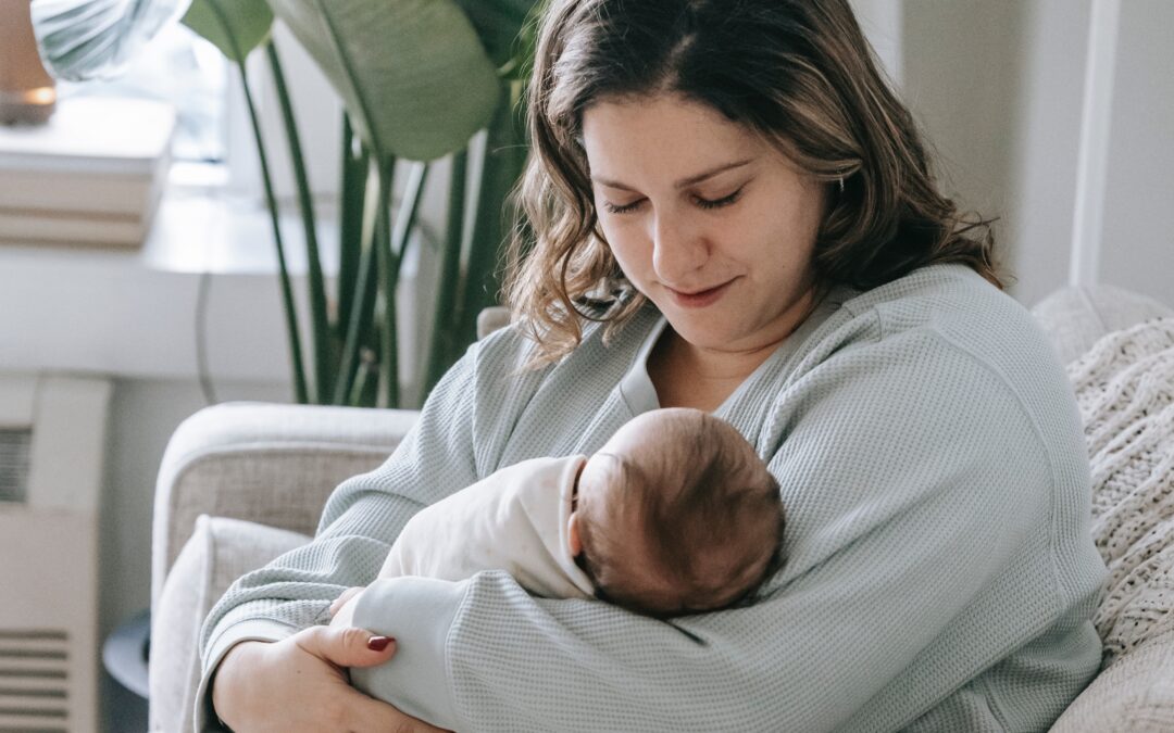 mom holding her baby to follow a Nap Schedule | The Peaceful Sleeper