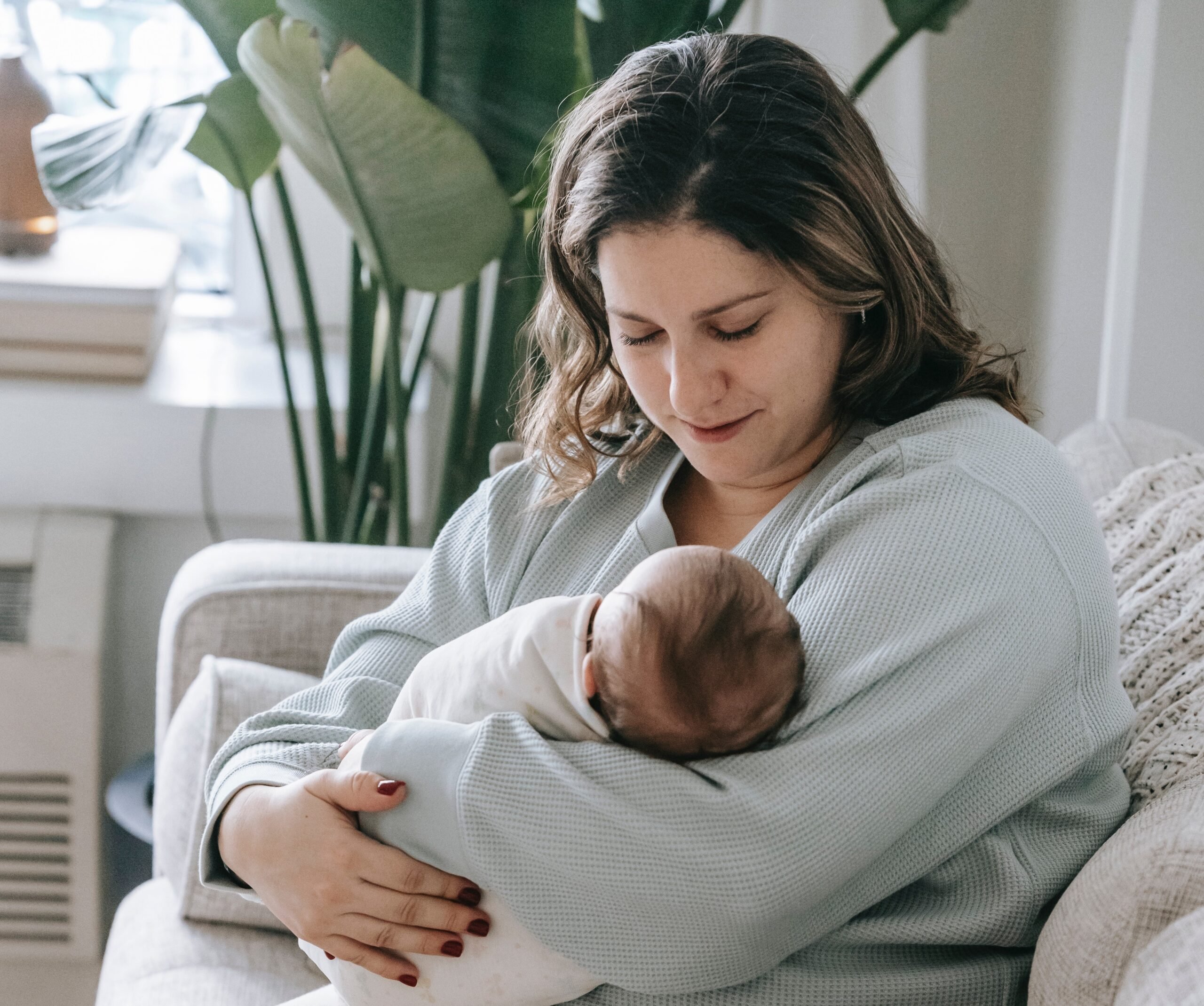 mom holding her baby to follow a Nap Schedule | The Peaceful Sleeper