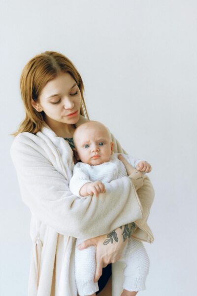 Mom Holding Baby - Sleep And Postpartum Well-Being | The Peaceful Sleeper