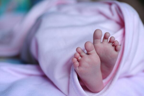 Baby Feet in Swaddle - When Can You Start Sleep Training Blog | The Peaceful Sleeper