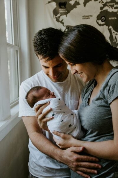 Swaddled Baby With Mom and Dad | The Peaceful Sleeper