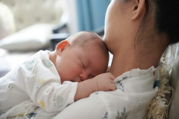 Mom Holding Baby | The Peaceful Sleeper