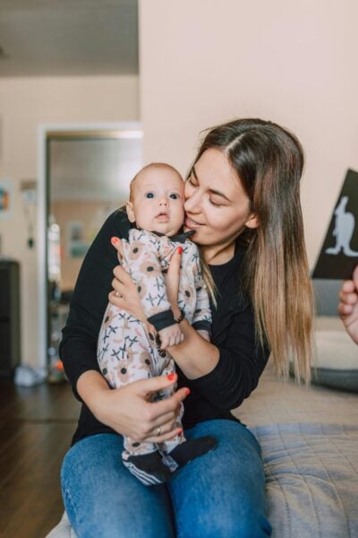 Mom Holding Baby | The Peaceful Sleeper