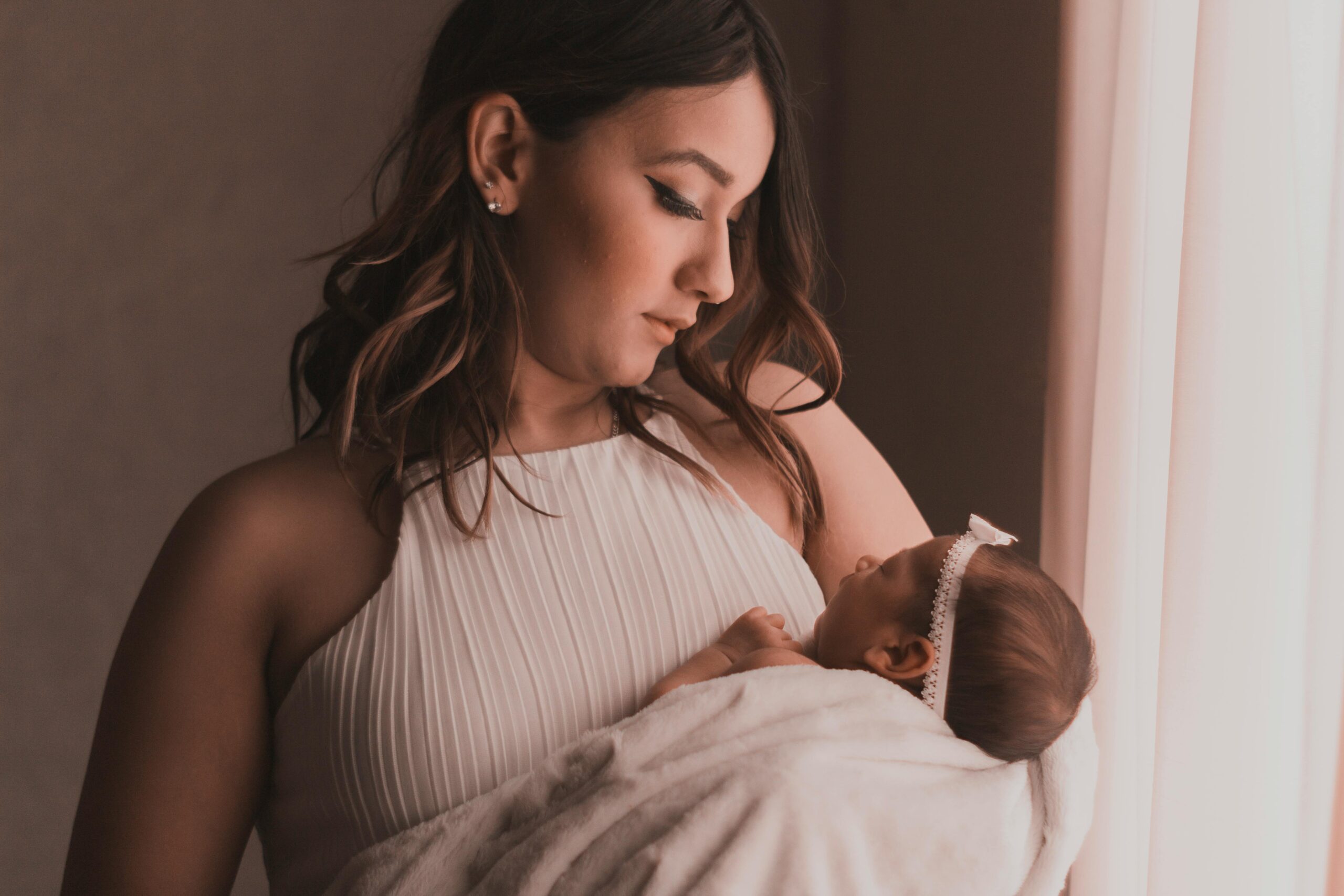 Mom Holding Baby - Night Wakings Blog | The Peaceful Sleeper