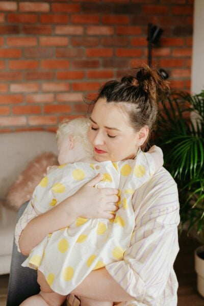 Mom Holding Baby | The Peaceful Sleeper