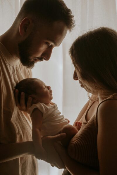 Mom and Dad Holding Newborn | The Peaceful Sleeper
