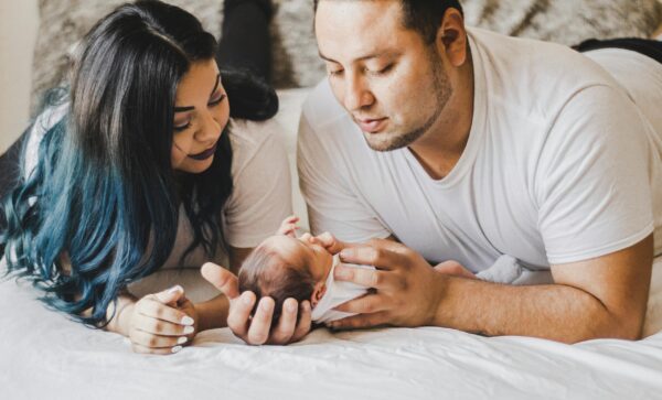 Mom and Dad Holding Baby | The Peaceful Sleeper
