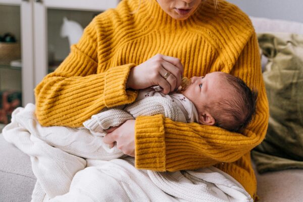 Mom Holding Newborn | The Peaceful Sleeper